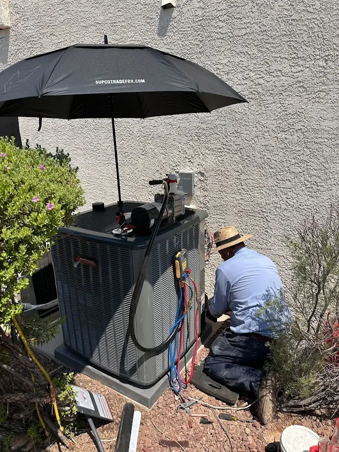 HVAC technician performing outdoor AC maintenance in Irondale